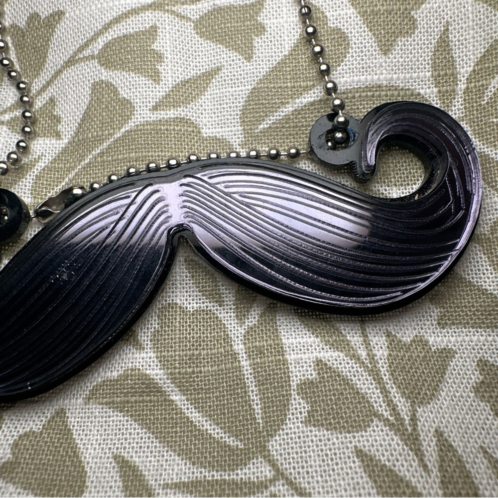 Handmade women’s mustache necklace black on Silvertone ball chain.